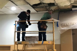 Local 174 Carpenters Volunteers insulating ceiling