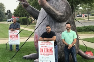 Picketers pose with Scabby